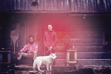 Image showing frineds together in front of old wooden house