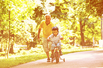 Image showing grandfather and child have fun  in park