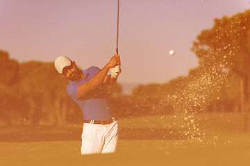 Image showing pro golfer hitting a sand bunker shot