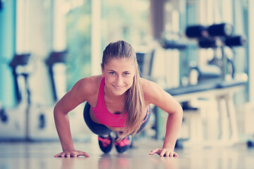 Image showing warming up and doing some push ups a the gym