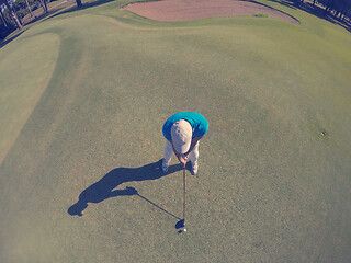 Image showing top view of golf player hitting shot