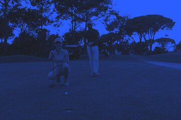 Image showing couple on golf course at sunset