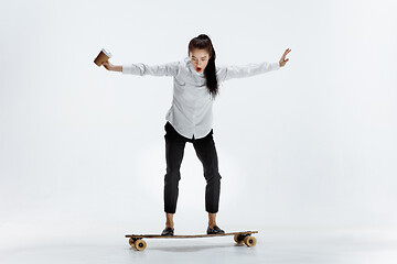 Image showing businesswoman riding skate on white background
