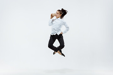 Image showing Happy business woman dancing and smiling isolated on white.