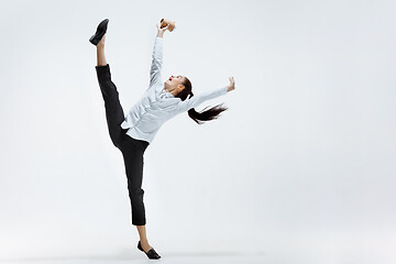 Image showing Happy business woman dancing and smiling isolated on white.