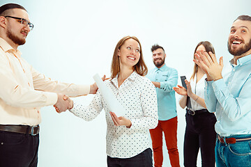 Image showing Boss approving and congratulating young successful employee