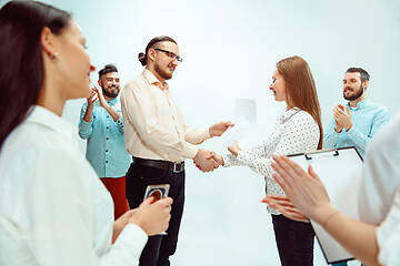 Image showing Boss approving and congratulating young successful employee