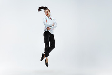 Image showing Happy business woman dancing and smiling isolated on white.