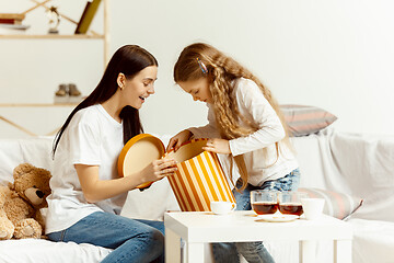 Image showing Little girl, attractive young mother are sitting at home