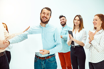 Image showing Boss approving and congratulating young successful employee