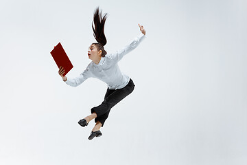 Image showing Happy business woman dancing and smiling isolated on white.