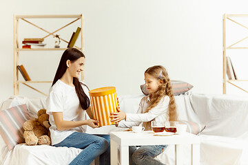 Image showing Little girl, attractive young mother are sitting at home