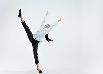 Image showing Happy business woman dancing and smiling isolated on white.