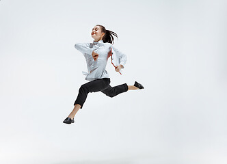 Image showing Happy business woman dancing and smiling isolated on white.