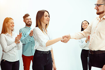 Image showing Boss approving and congratulating young successful employee