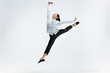 Image showing Happy business woman dancing and smiling isolated on white.