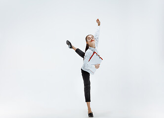 Image showing Happy business woman dancing and smiling isolated on white.