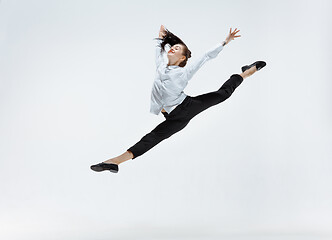 Image showing Happy business woman dancing and smiling isolated on white.