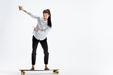 Image showing businesswoman riding skate on white background