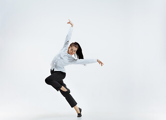 Image showing Happy business woman dancing and smiling isolated on white.