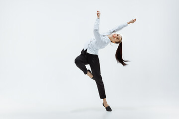 Image showing Happy business woman dancing and smiling isolated on white.