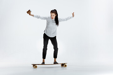 Image showing businesswoman riding skate on white background