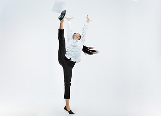 Image showing Happy business woman dancing and smiling isolated on white.
