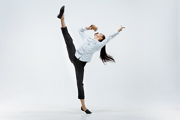 Image showing Happy business woman dancing and smiling isolated on white.