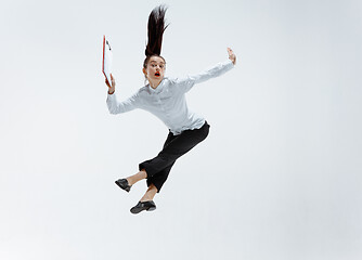 Image showing Happy business woman dancing and smiling isolated on white.