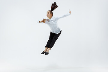 Image showing Happy business woman dancing and smiling isolated on white.