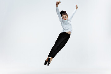 Image showing Happy business woman dancing and smiling isolated on white.