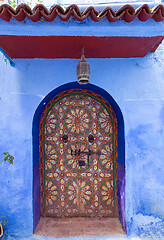 Image showing ornate color door on street in Morocco