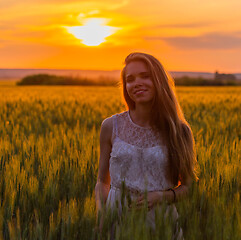 Image showing Pretty girl in field at sunset