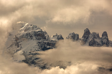 Image showing Snow-capped alps mountains in clouds