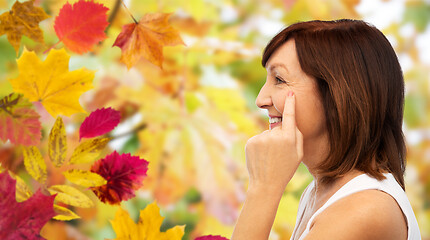 Image showing profile of senior woman pointing to eye wrinkles