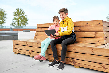 Image showing children with tablet computer sitting on bench