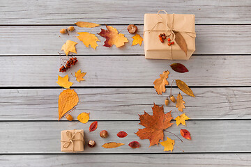 Image showing frame of gifts, autumn leaves and rowanberry