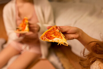 Image showing happy female friends eating pizza at home