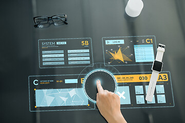 Image showing close up of hand using interactive panel with data