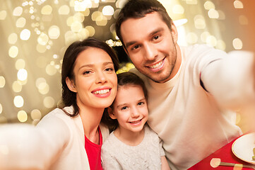 Image showing happy family taking selfie at christmas