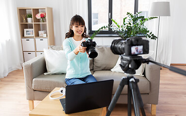 Image showing asian female blogger with camera recording video