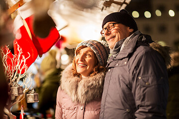 Image showing senior couple at christmas market souvenir shop