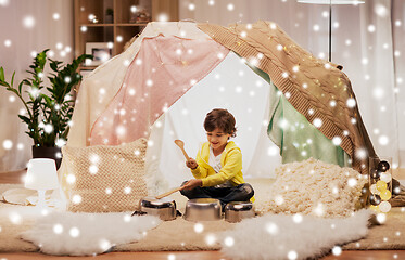 Image showing boy with pots playing music in kids tent at home