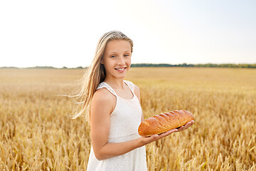 Image showing girl with loaf of white bread on cereal field