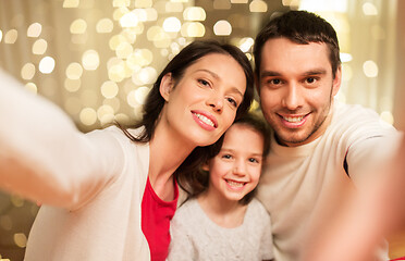 Image showing happy family taking selfie at christmas