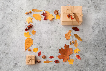 Image showing frame of gifts, autumn leaves and rowanberry