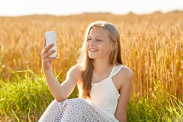 Image showing happy young girl taking selfie by smartphone