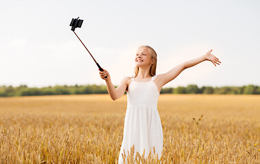 Image showing happy young girl taking selfie by smartphone