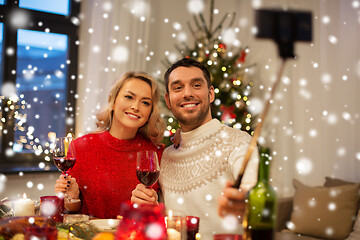 Image showing couple taking picture by selfie stick at christmas