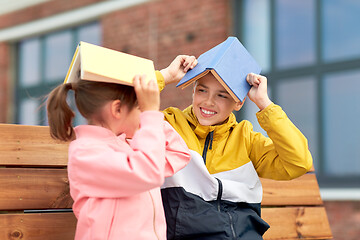 Image showing school children with books having fun outdoors